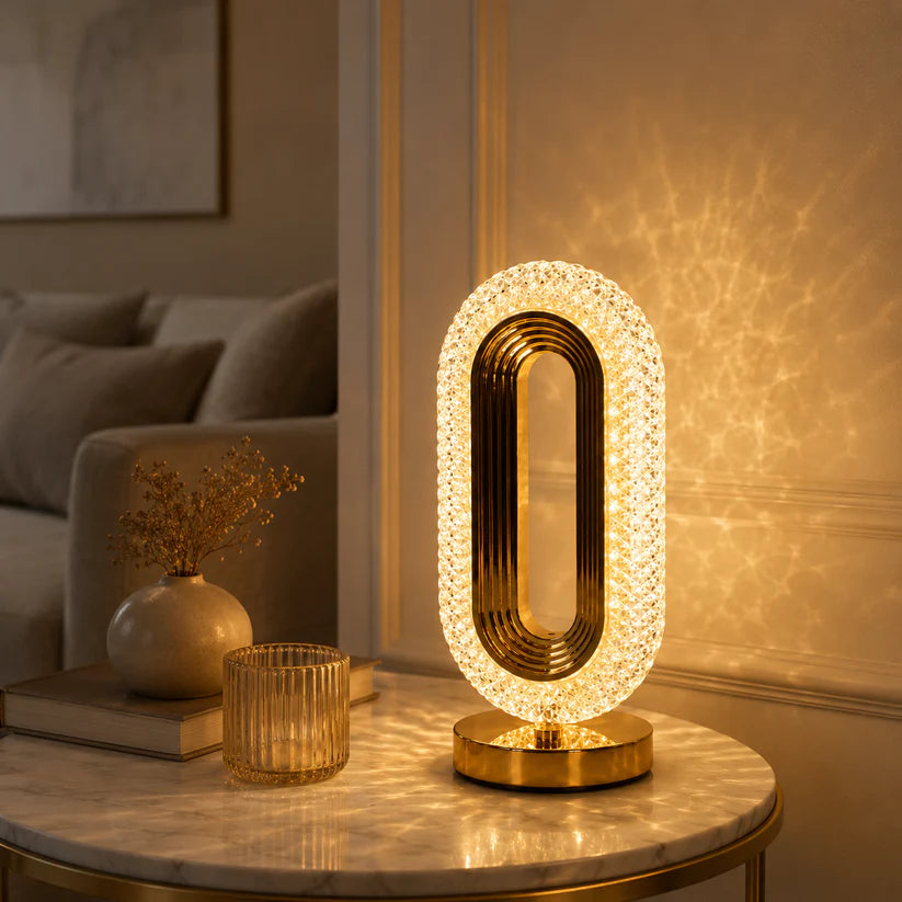 Oval crystal table lamp warm glow on marble side table
