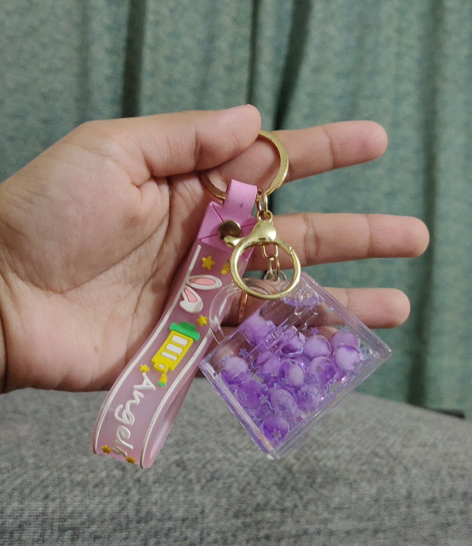 Cute bubble keychain pink with wrist strap on notebook