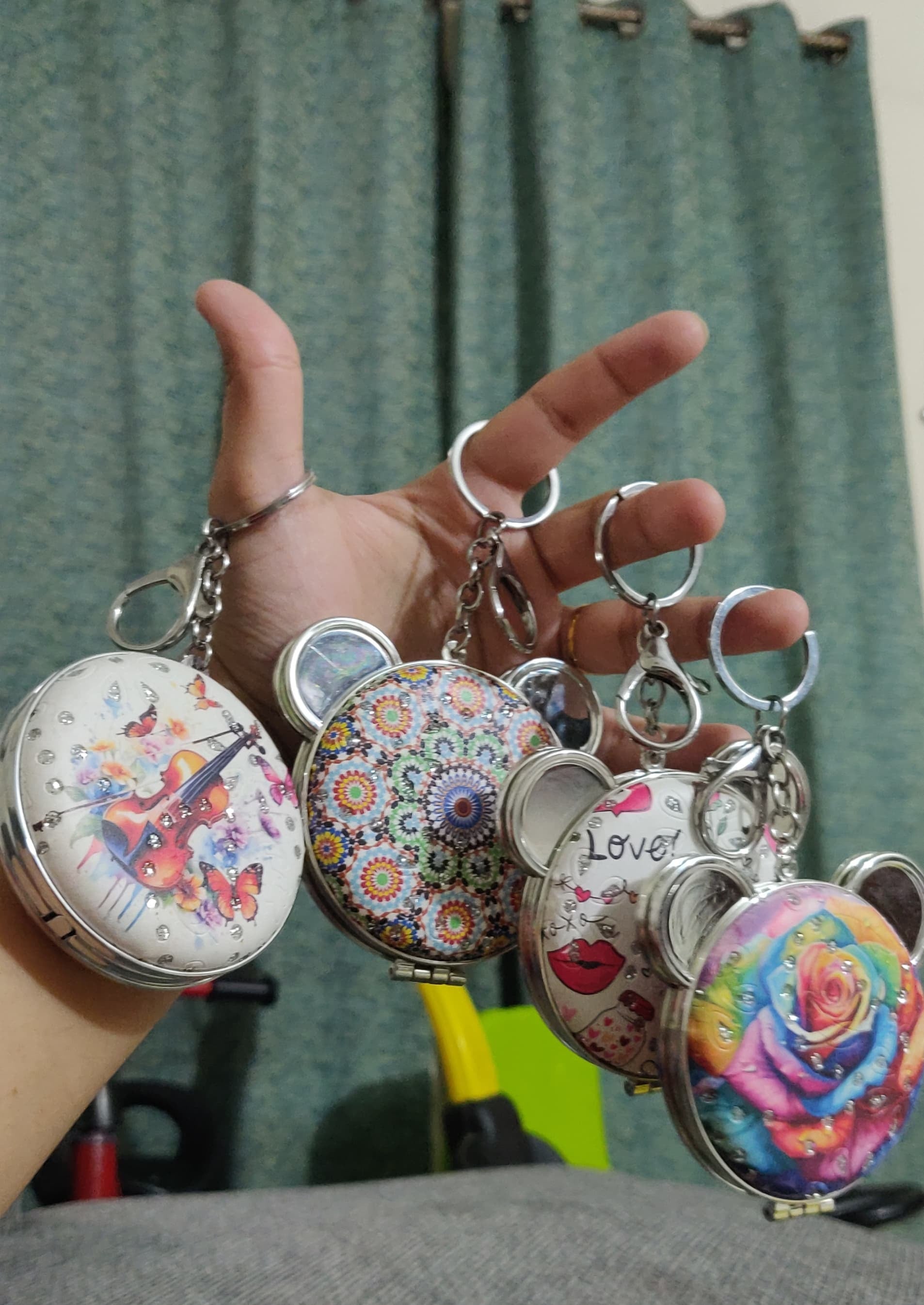 Bear compact mirror keychain open showing blue tinted mirror in mall