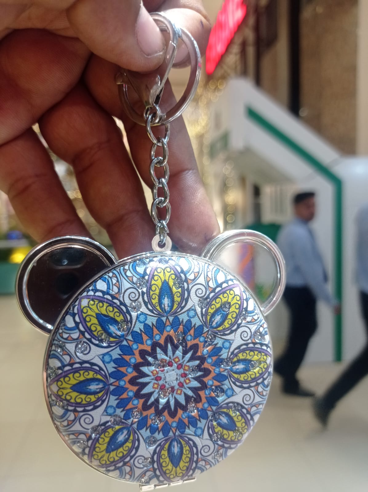 Bear compact mirror keychain open showing dual mirrors held in hand