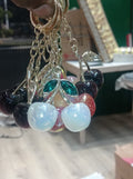 Crystal cherry keychain held in hand showing red and pink variants