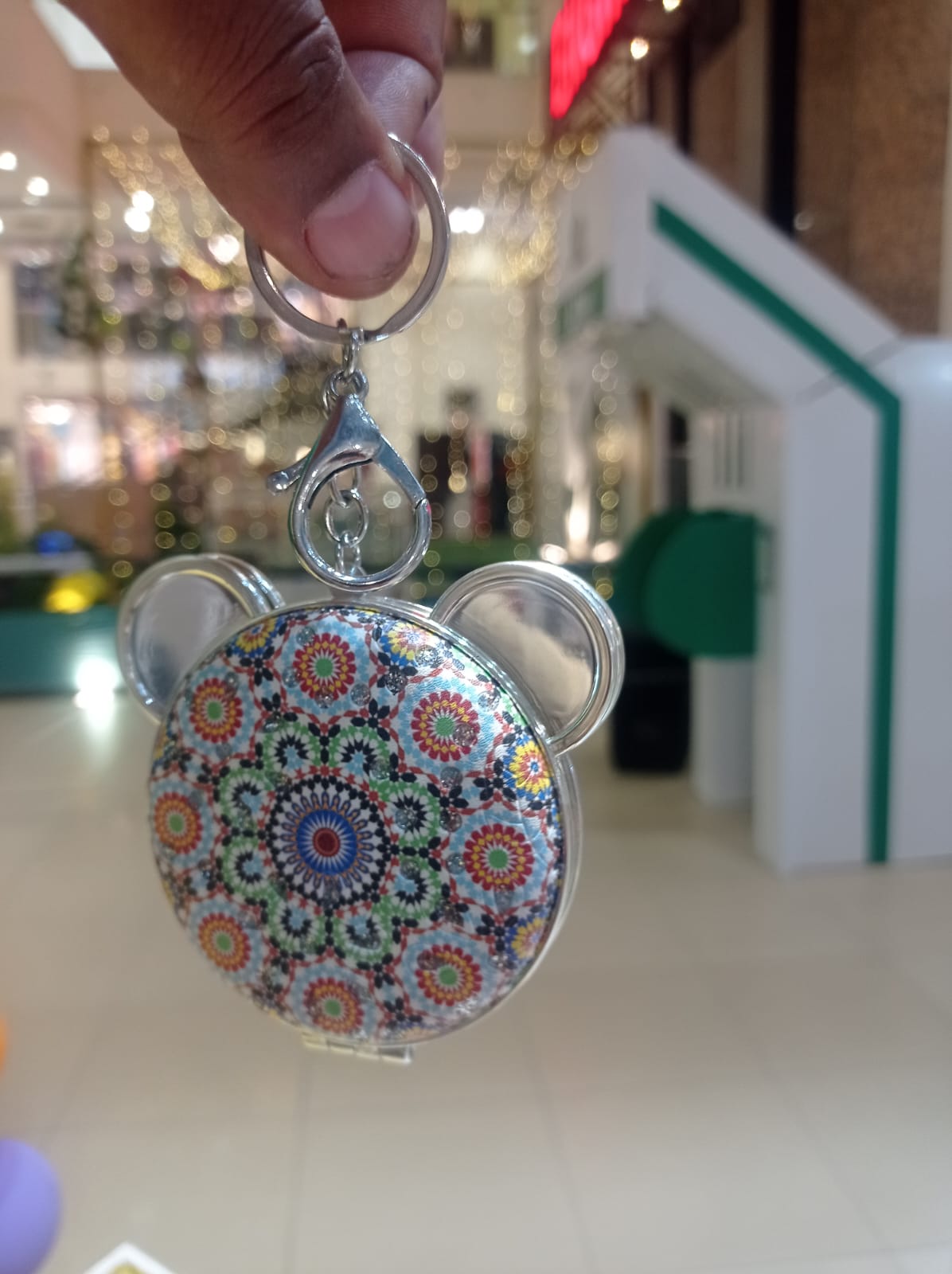 Bear compact mirror keychain with mandala print held in hand
