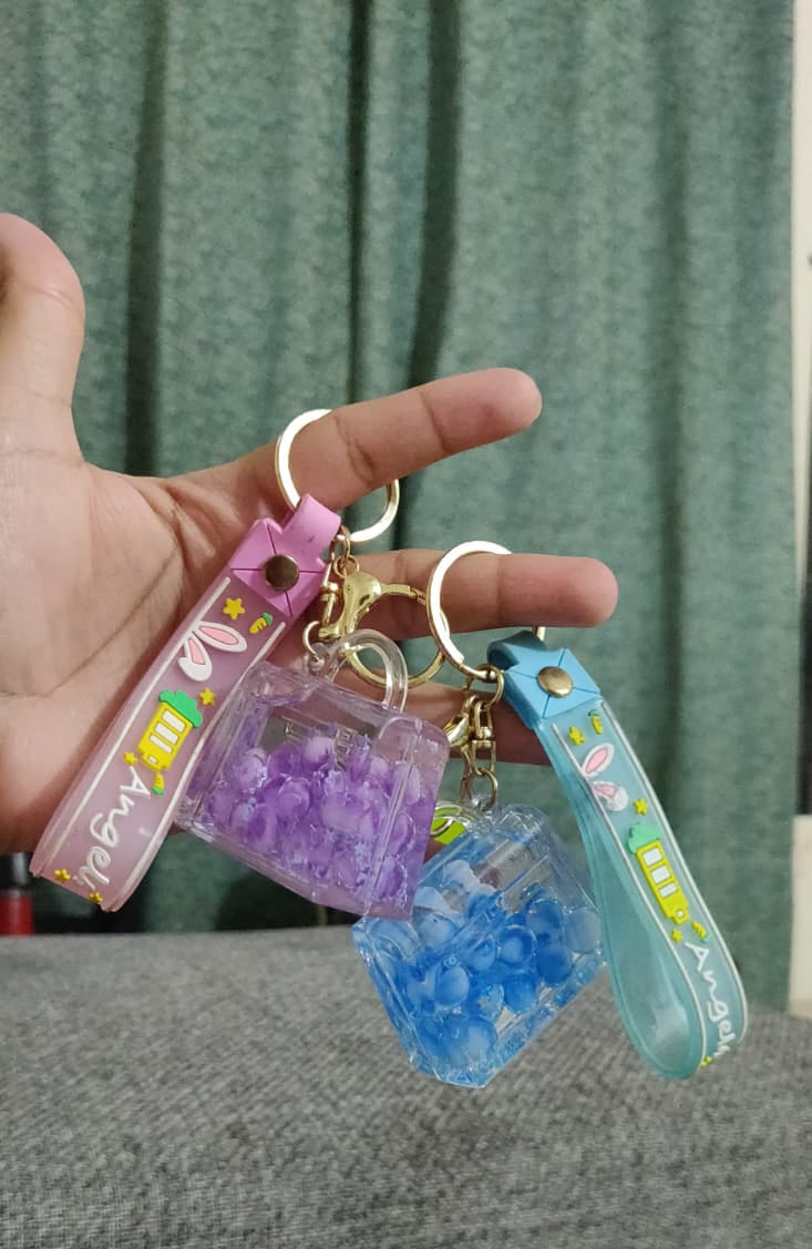 Green bubble cup keychain in hand